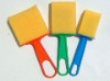 yellow sponge brush with colored plastic handle